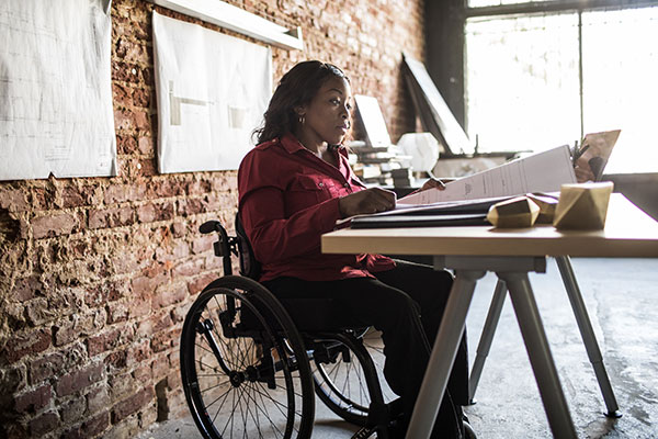 Woman in a wheelchair at a desk